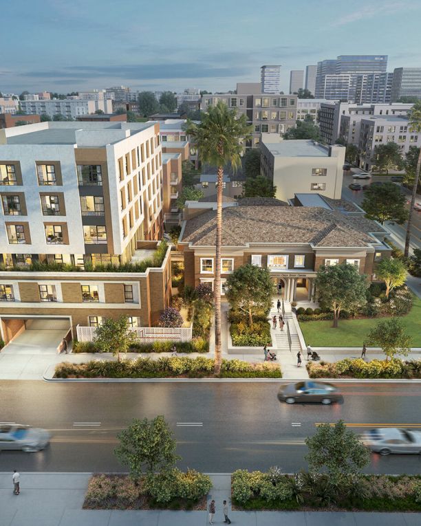Aerial view of a modern residential campus with palm trees, landscaped courtyards, and nearby busy streets in a city.